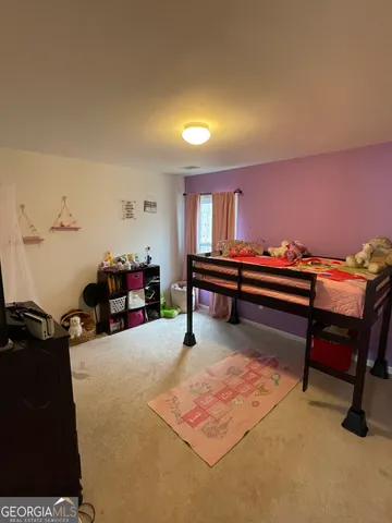 a bedroom with furniture and a chair