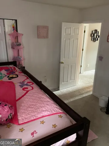 a bed sitting in a bedroom next to a window