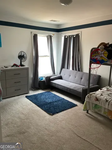 a bedroom with two beds and a window