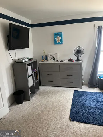 a bedroom with a bed and flat screen tv