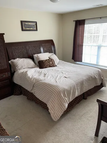 a bedroom with bed and a window