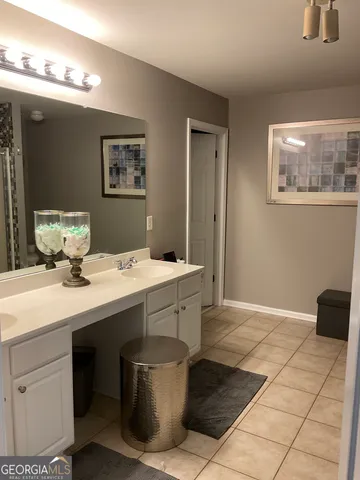 a kitchen with a sink cabinets and wooden floor