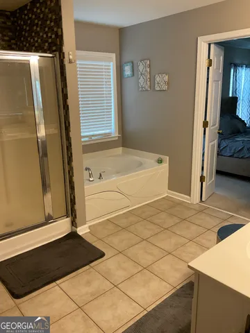a bathroom with a bathtub and a shower