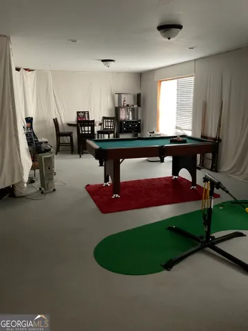 a room with lots of wooden furniture and windows