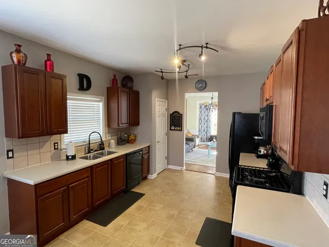 a kitchen with stainless steel appliances a sink stove and refrigerator
