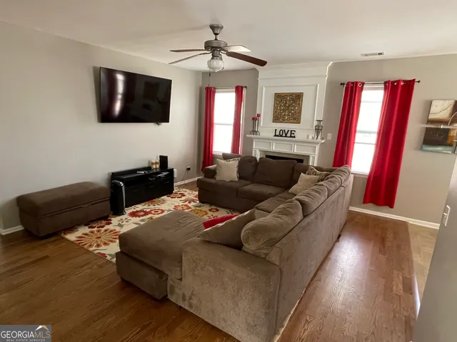 a living room with furniture flat screen tv and a fireplace
