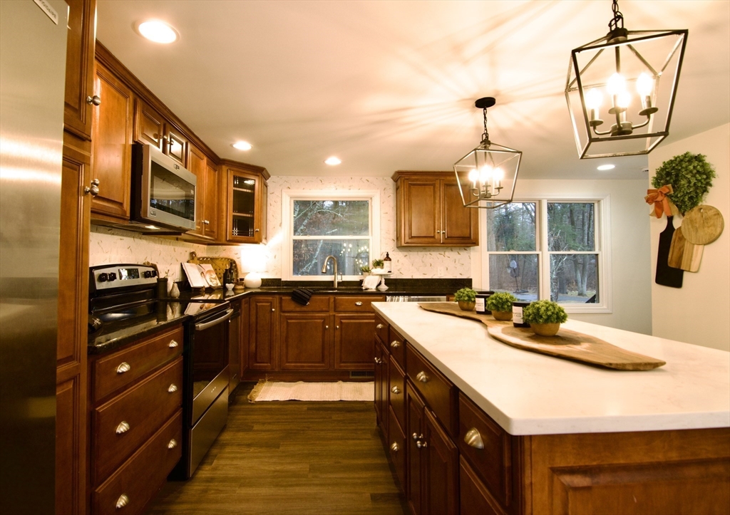 12 Rose Circle Hampden, MA 01036 - Photo 13 of 41 a kitchen with a sink stove and cabinets