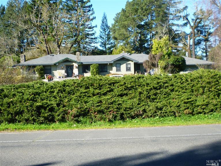 a small white house with a street view