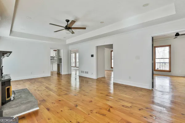 a kitchen with granite countertop a stove a refrigerator and a sink with wooden floor