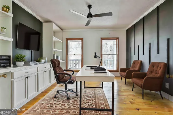 a kitchen with stainless steel appliances white cabinets and wooden floor