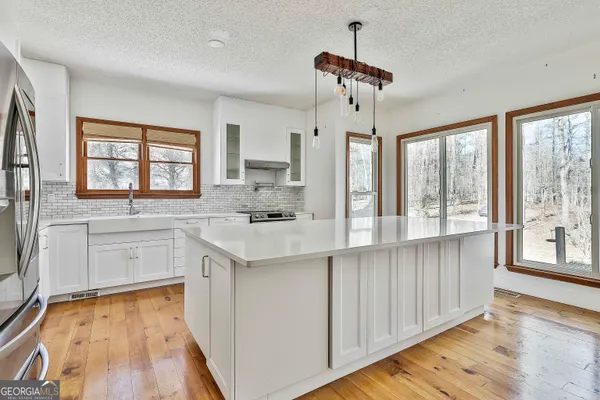 a bathroom with a sink vanity and mirror