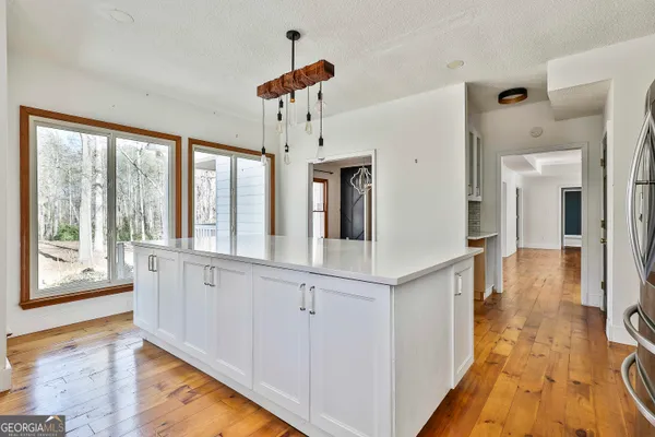 a bedroom with a bed window and a flat screen tv