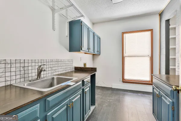 a view of a room with a ceiling fan and a window