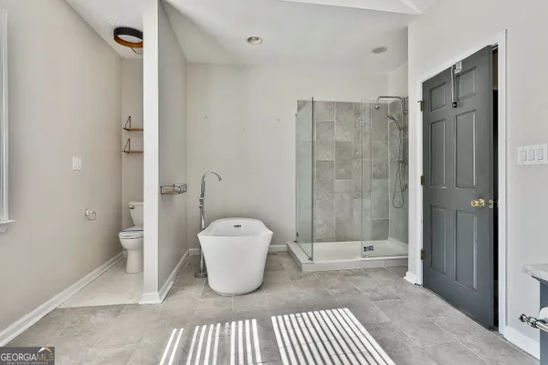 a bedroom with a bed and a fireplace