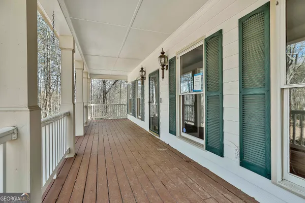 a view of a hallway with wooden floor and a window