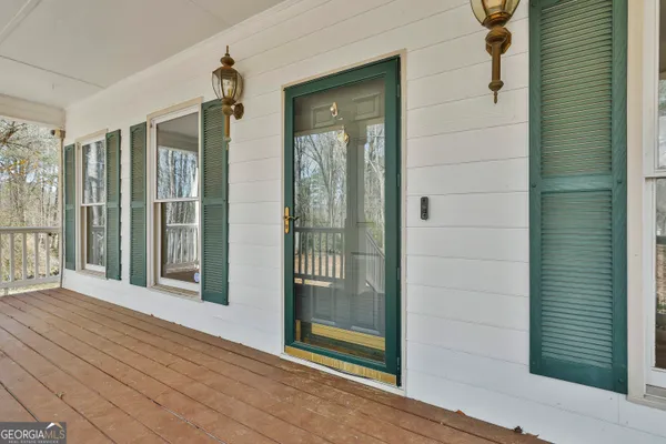 a view of a hallway with wooden floor and chandelier