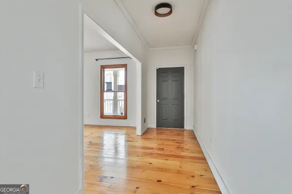 an empty room with floor to ceiling windows and fireplace