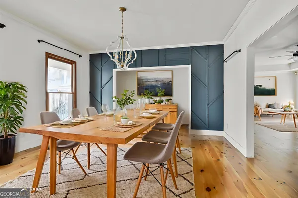 a view of a livingroom with wooden floor and a ceiling fan