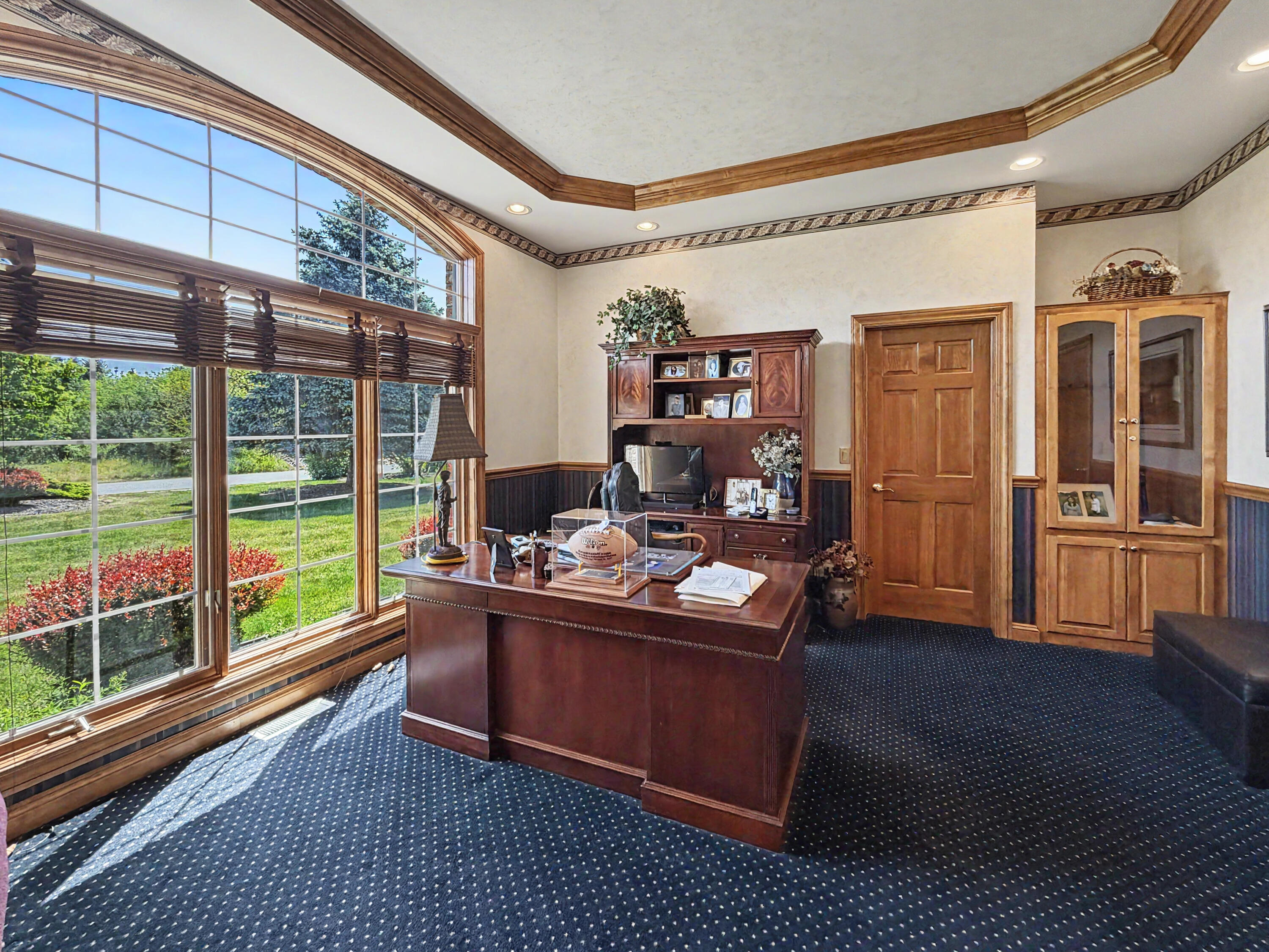 W291-s5245 Ridgefield Road Waukesha, WI 53189 - Photo 24 of 44 Beautiful main-floor third bedroom or optional office, highlighted by a tray ceiling, stunning arched window, French doors, and a spacious walk-in closet. This flexible space offers the perfect setting for a private office, library, guest suite, or additional bedroom.
