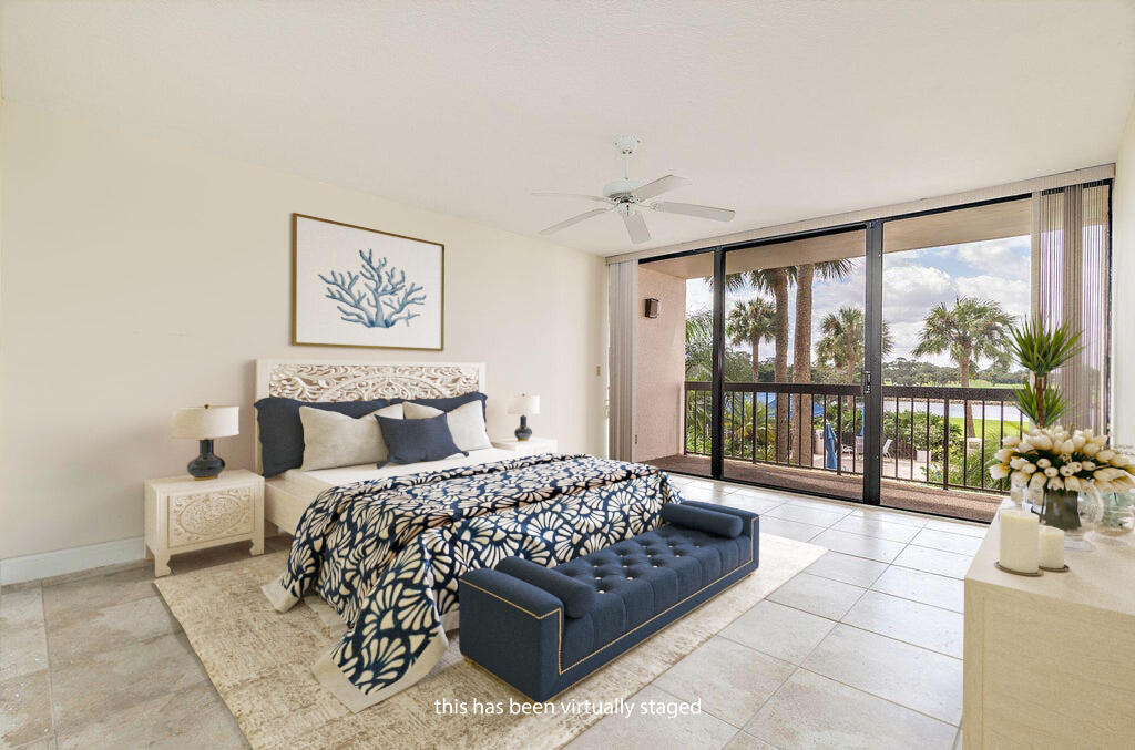 356 Golfview Road, Unit 204 North Palm Beach, FL 33408 - Photo 11 of 71 a bedroom with a large bed and a large window