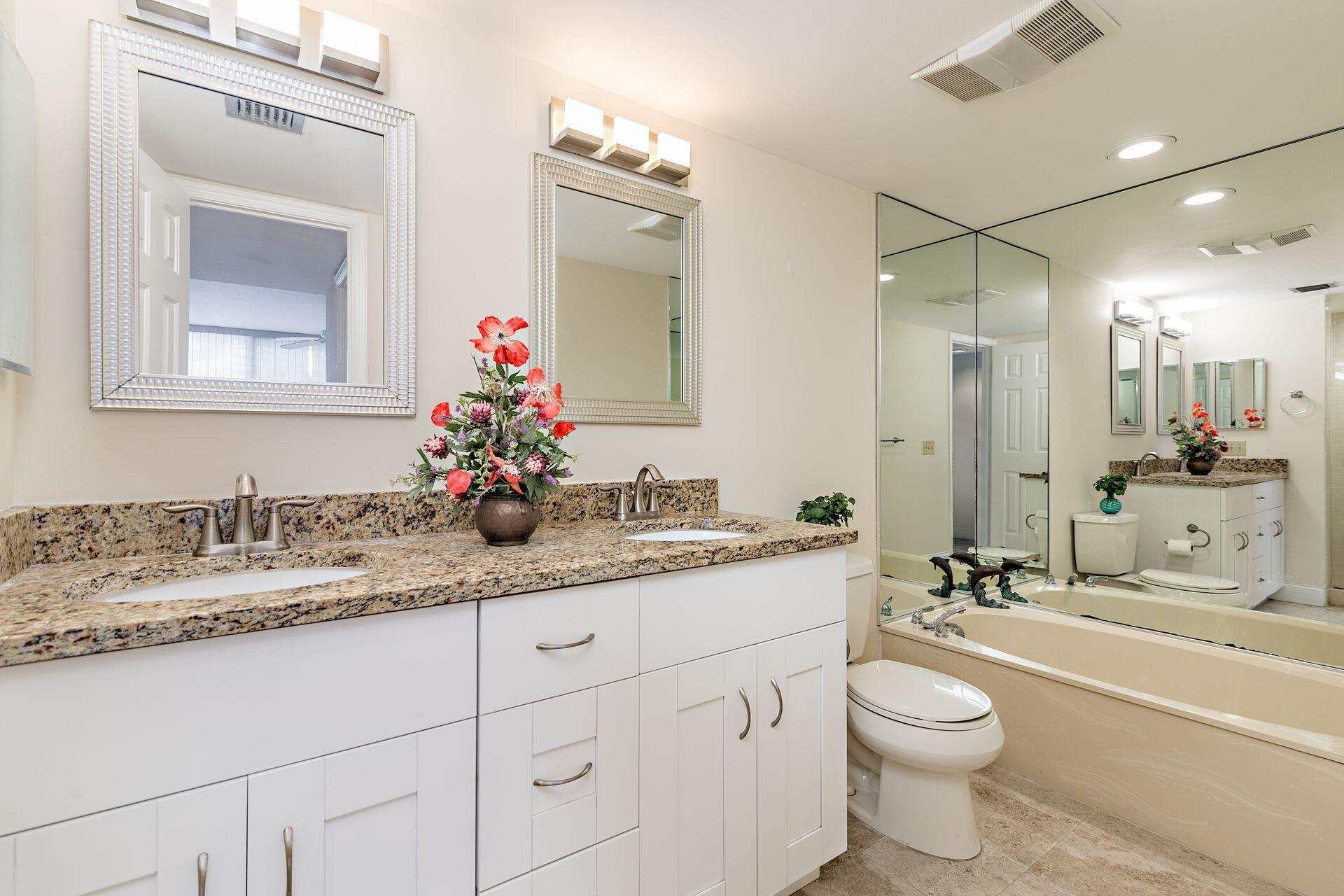 356 Golfview Road, Unit 204 North Palm Beach, FL 33408 - Photo 12 of 71 a bathroom with a granite countertop sink mirror and a toilet