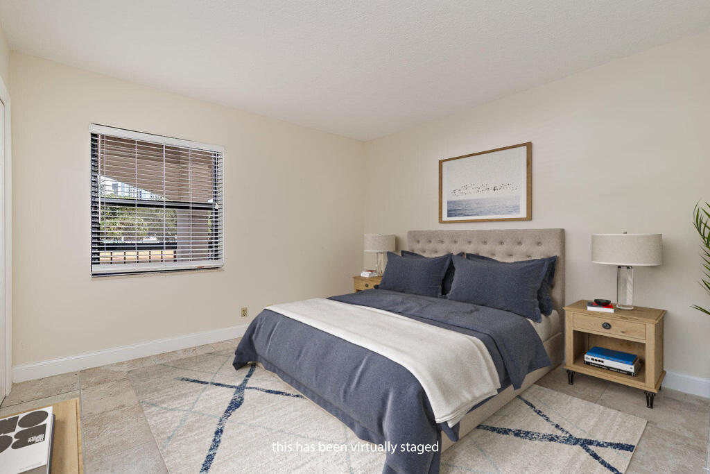 356 Golfview Road, Unit 204 North Palm Beach, FL 33408 - Photo 14 of 71 a bedroom with a bed and a tv