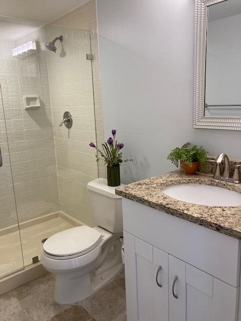 356 Golfview Road, Unit 204 North Palm Beach, FL 33408 - Photo 22 of 71 a bathroom with a granite countertop sink toilet and shower