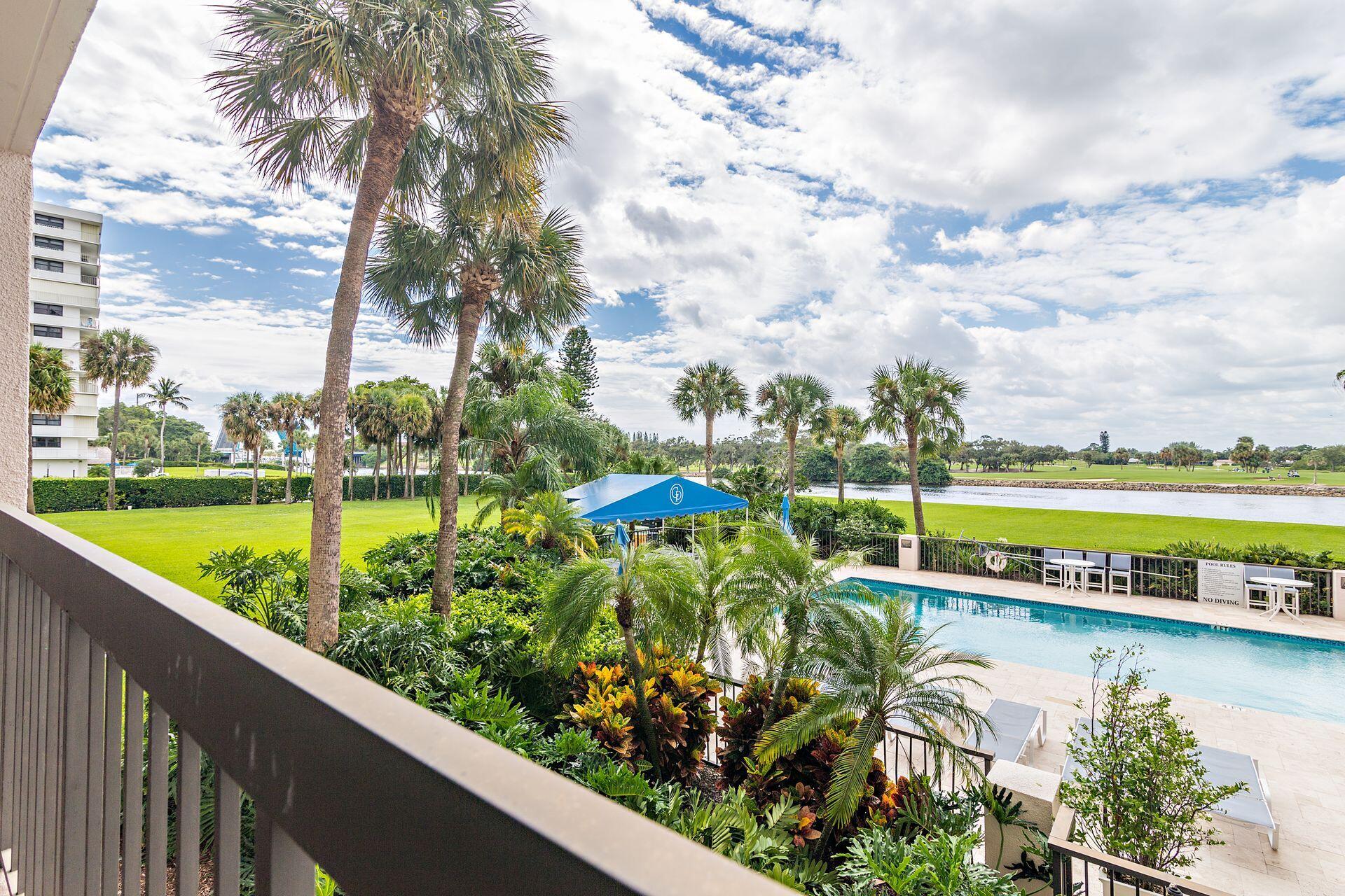 356 Golfview Road, Unit 204 North Palm Beach, FL 33408 - Photo 26 of 71 a view of a swimming pool with a patio and a garden