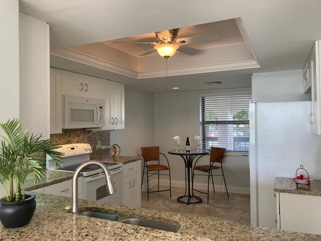 356 Golfview Road, Unit 204 North Palm Beach, FL 33408 - Photo 8 of 71 a dining room with furniture and wooden floor