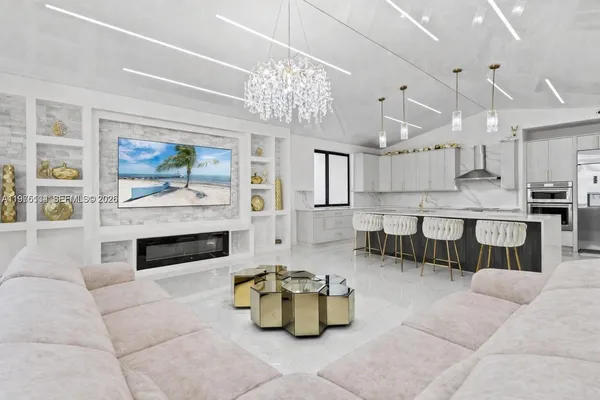 a living room with furniture and a chandelier