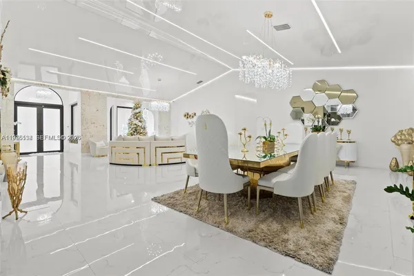 a dining room with furniture and chandelier