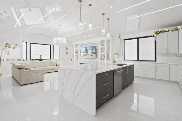 a large white kitchen with a large window