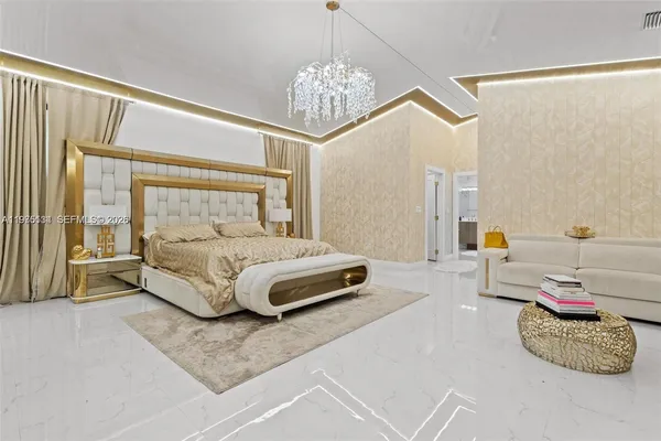 a bedroom with a bed and a chandelier