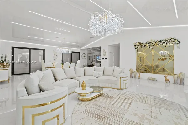 a living room with furniture and a chandelier
