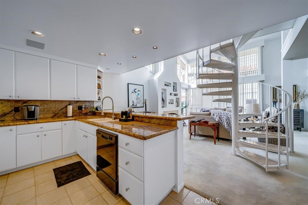 555 Esplanade, Unit 518 Redondo Beach, CA 90277 - Photo 23 of 73 a kitchen with stainless steel appliances granite countertop a sink and cabinets