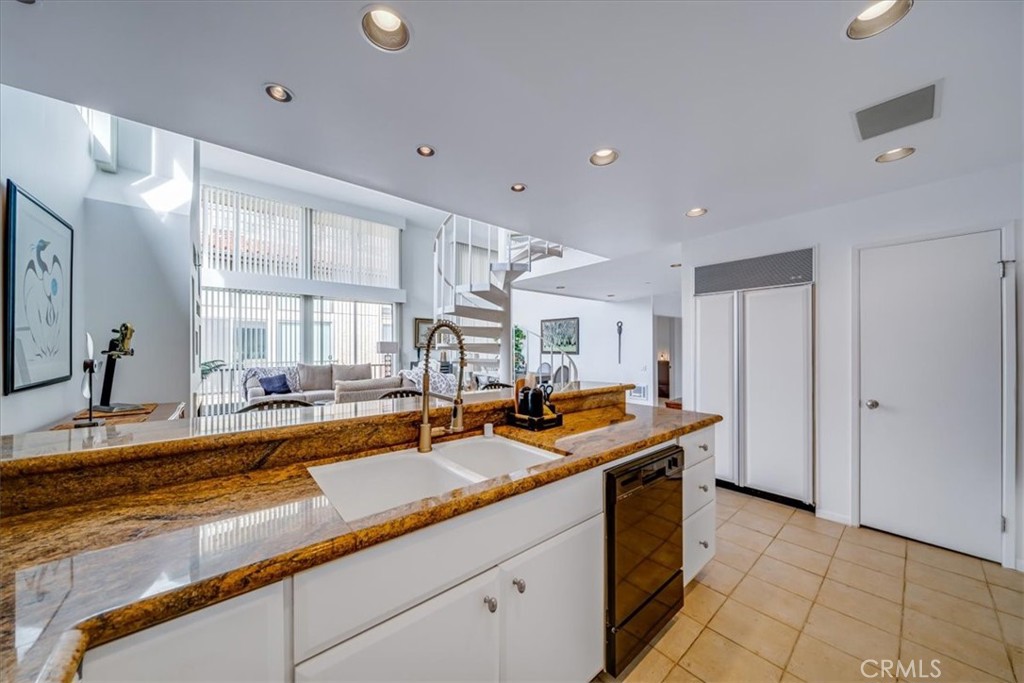 555 Esplanade, Unit 518 Redondo Beach, CA 90277 - Photo 24 of 73 a kitchen with stainless steel appliances granite countertop a sink a stove and a refrigerator