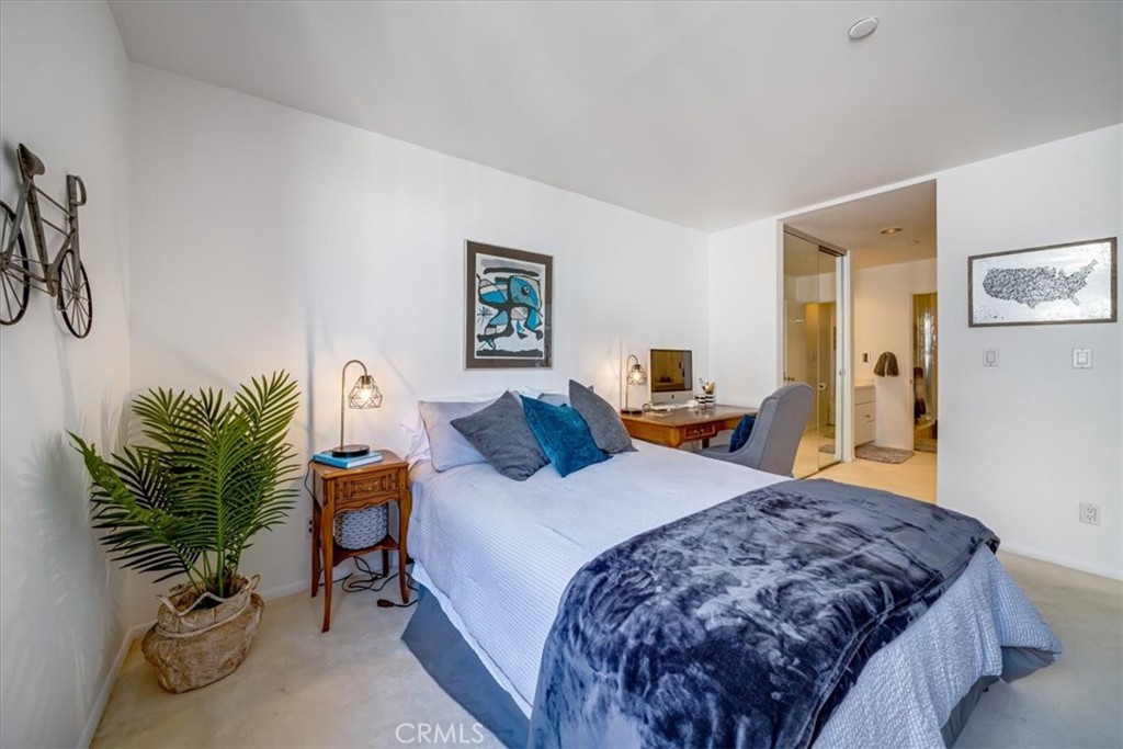 555 Esplanade, Unit 518 Redondo Beach, CA 90277 - Photo 29 of 73 a bedroom with a bed and a potted plant