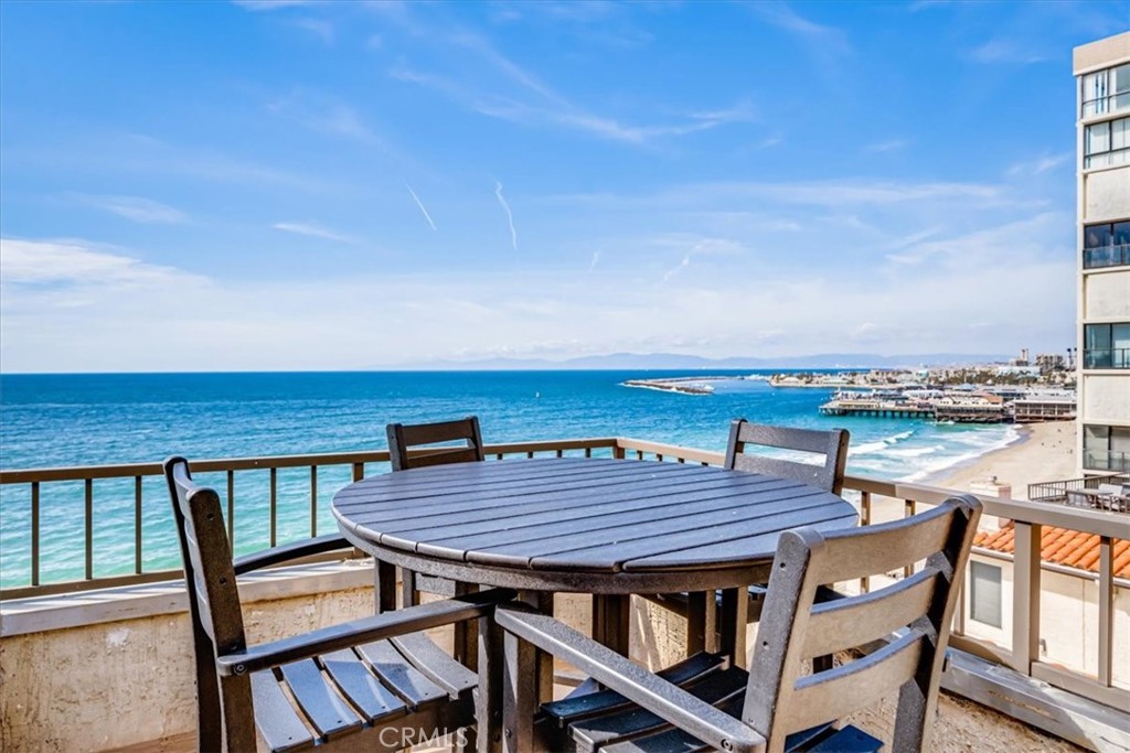 555 Esplanade, Unit 518 Redondo Beach, CA 90277 - Photo 3 of 73 a roof deck with a table and chairs