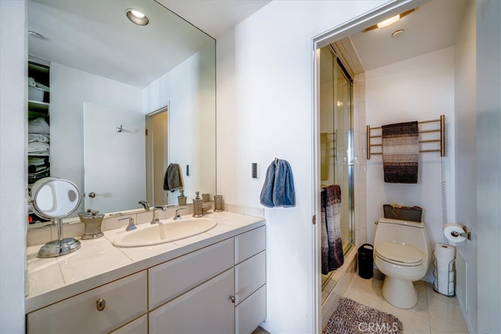 555 Esplanade, Unit 518 Redondo Beach, CA 90277 - Photo 31 of 73 a bathroom with a toilet sink double vanity and mirror