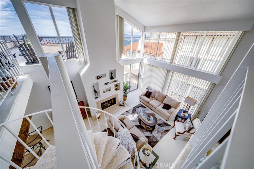 555 Esplanade, Unit 518 Redondo Beach, CA 90277 - Photo 34 of 73 a living room with furniture and a floor to ceiling window