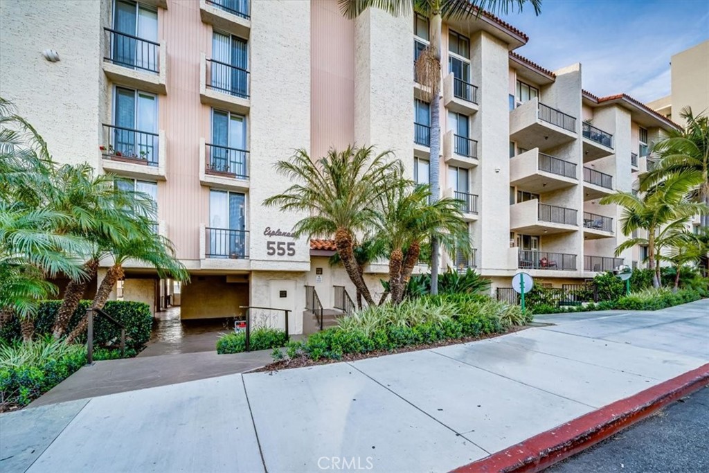 555 Esplanade, Unit 518 Redondo Beach, CA 90277 - Photo 70 of 73 a front view of a multi story residential apartment building with yard and bench