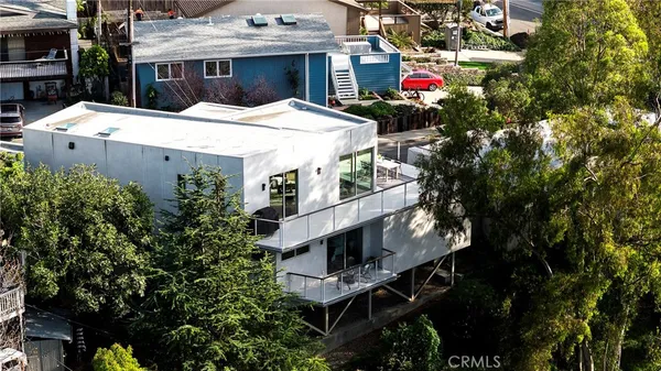 a bedroom with a bed couch and a large window
