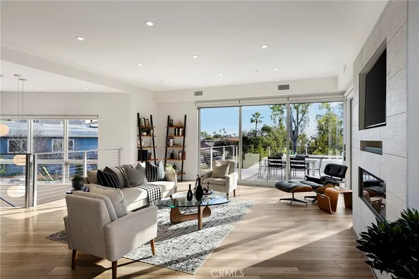 a kitchen with stainless steel appliances granite countertop a sink a stove a refrigerator cabinets and dining table