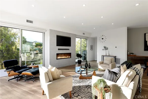 a kitchen with stainless steel appliances a sink a stove and a wooden floors