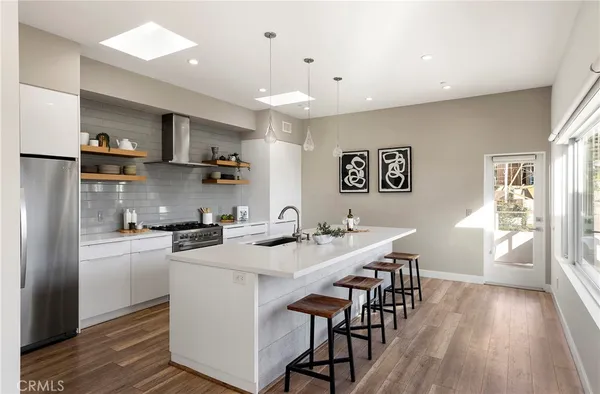 a living room with furniture a flat screen tv and a large window