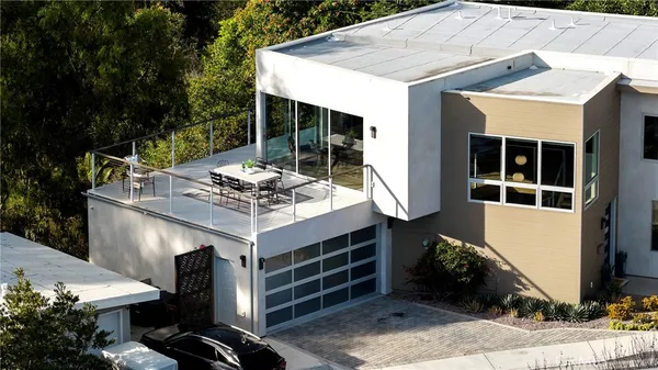 a view of a chairs and table in a balcony