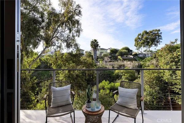 a bedroom with a large bed and a potted plant