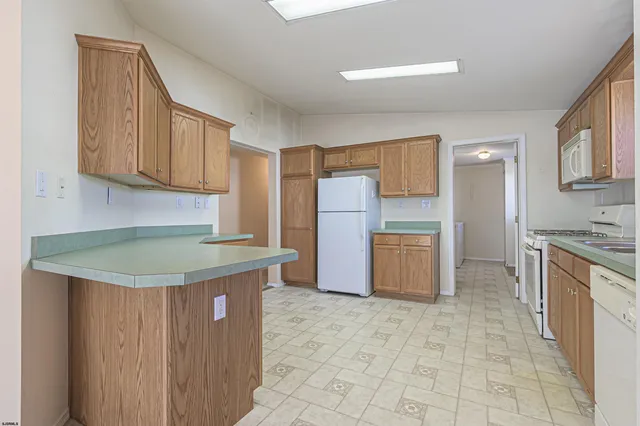 a kitchen with stainless steel appliances granite countertop a stove a refrigerator and a sink