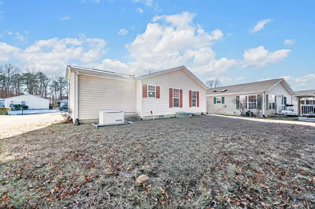 a bedroom with a bed dresser and window