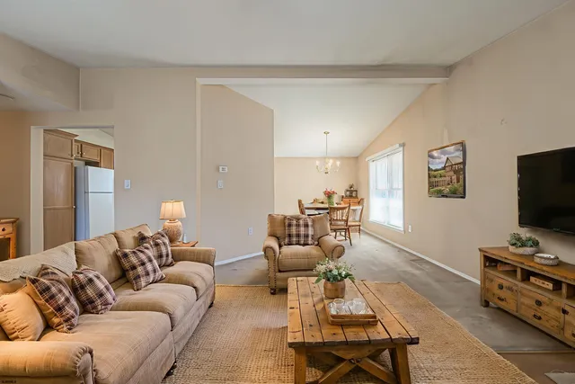 a living room with furniture a flat screen tv and a couch